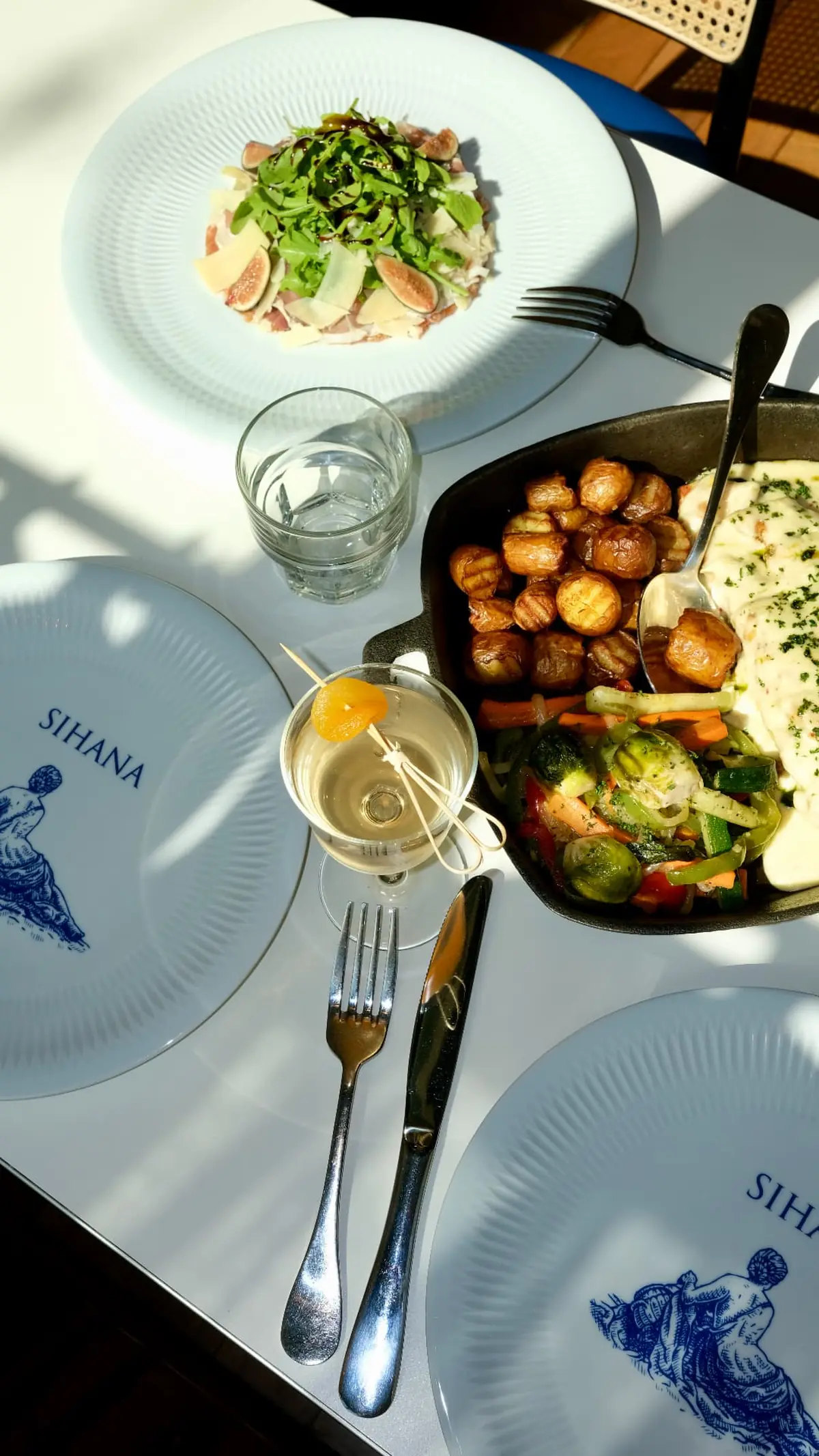 A long table set with Mediterranean dishes at Sihana Bistro